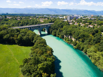 Aerial view of arch bridge over river amidst trees