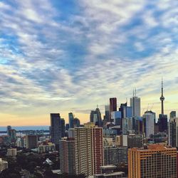 Cityscape against cloudy sky