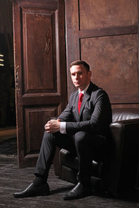 Portrait of businessman sitting on sofa indoors