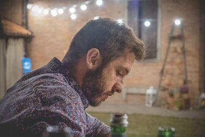 Man sitting in illuminated room