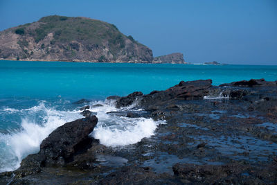 Scenic view of sea against clear blue sky