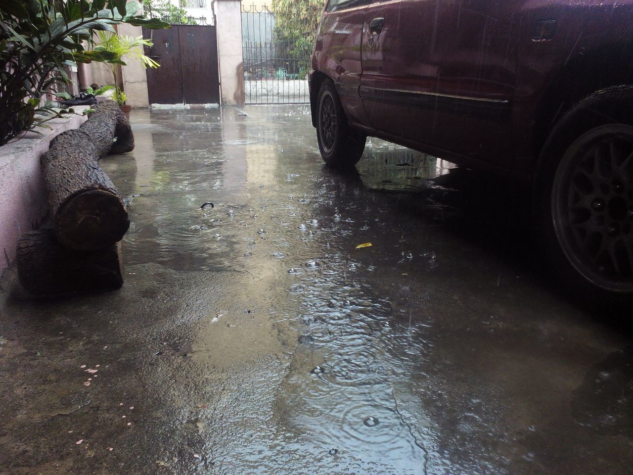 water, built structure, wet, street, architecture, building exterior, reflection, old, day, outdoors, fountain, puddle, no people, car, abandoned, land vehicle, stone material, transportation, weathered, close-up