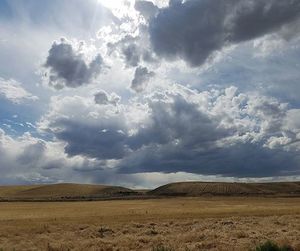 Scenic view of landscape against cloudy sky