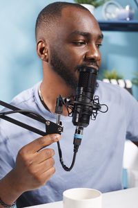 Cropped image of man holding camera