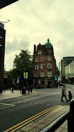 City street against cloudy sky