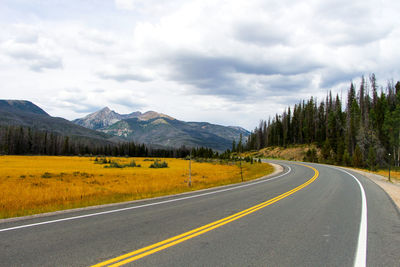 Empty road with mountains in background