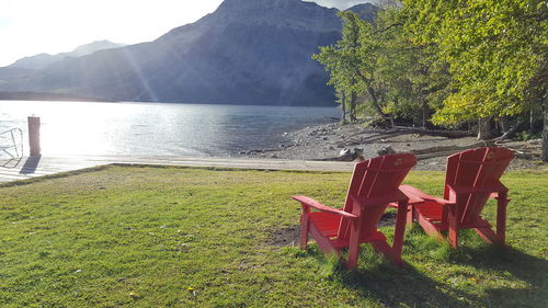 Empty chair on beach against sea