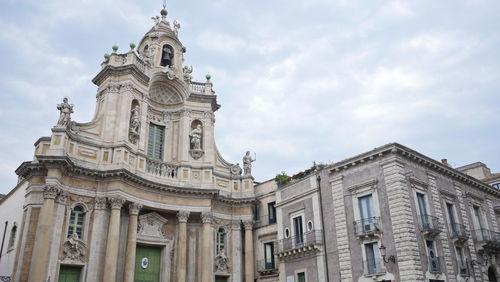 Low angle view of historical building against cloudy sky
