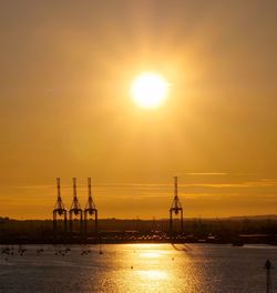 Scenic view of sea against orange sky