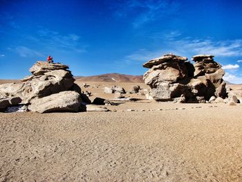 Rock formations on landscape against sky