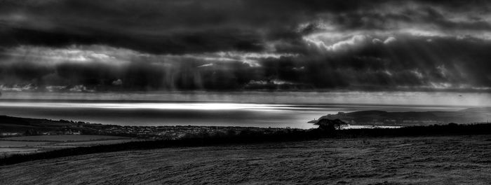 Scenic view of sea against storm clouds