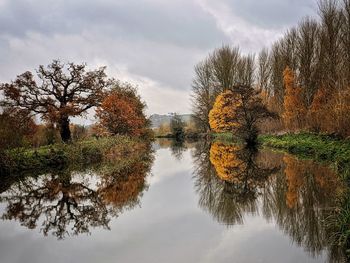 Reflection of trees in lake against sky during autumn