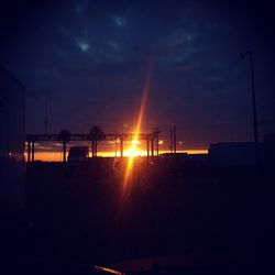 Factory against sky during sunset