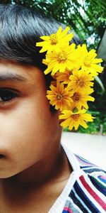 Portrait of woman by yellow flowering plant