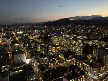 Aerial view of illuminated city buildings at night