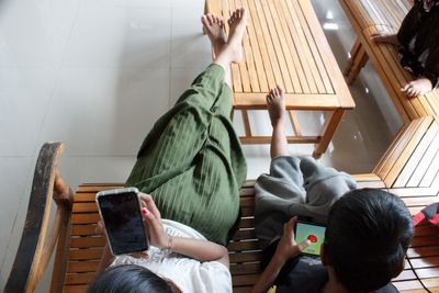 Rear view of woman using digital tablet