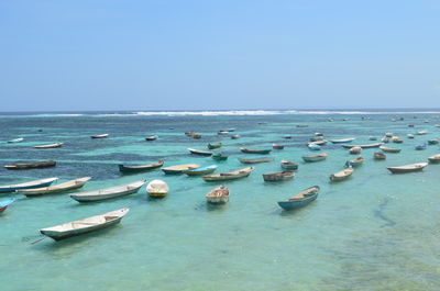 High angle view of boats moored at beach against clear sky