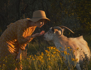 Person wearing hat on rock