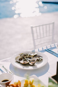 Close-up of oysters served in plate at poolside