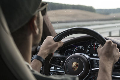 Midsection of man driving car