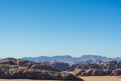 Scenic view of mountains against clear blue sky