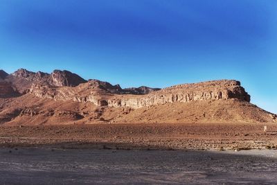 Scenic view of mountains against clear blue sky