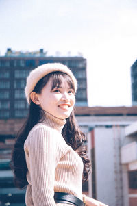Portrait of smiling young woman standing outdoors