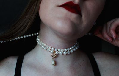 Midsection of woman wearing necklace