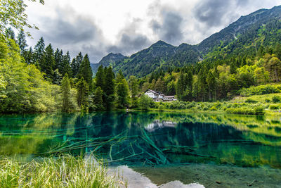 Scenic view of lake and mountains against sky