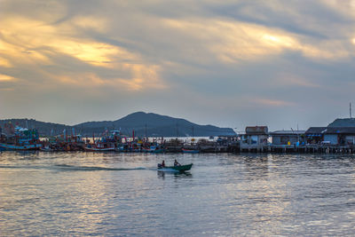 Scenic view of sea and buildings in city against sky