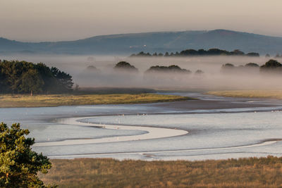 Scenic view of river during foggy weather