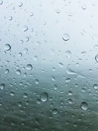 Full frame shot of raindrops on window