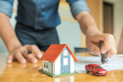 Close-up of hand holding toy on table