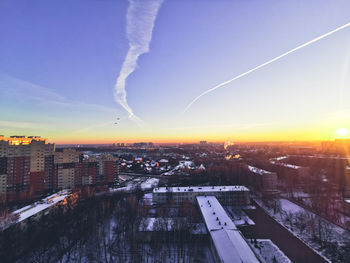 Aerial view of cityscape against sky during sunset