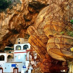 Low angle view of buildings and rock formation