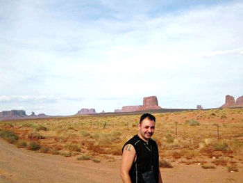 Portrait of a smiling young man standing on land