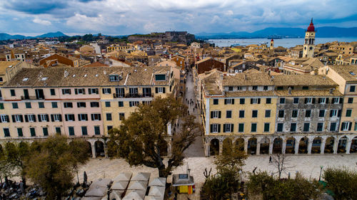 High angle view of buildings in town against sky