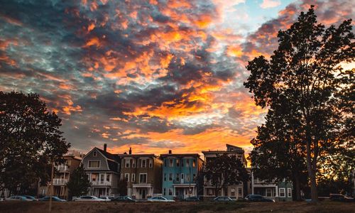 Scenic view of residential district against sky during sunset