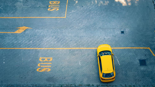 High angle view of yellow sign on road