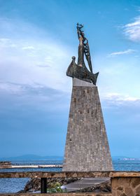 Low angle view of statue against cloudy sky