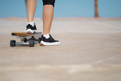 Low section of man skateboarding on skateboard