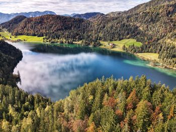 Scenic view of autumn lake and mountains against sky