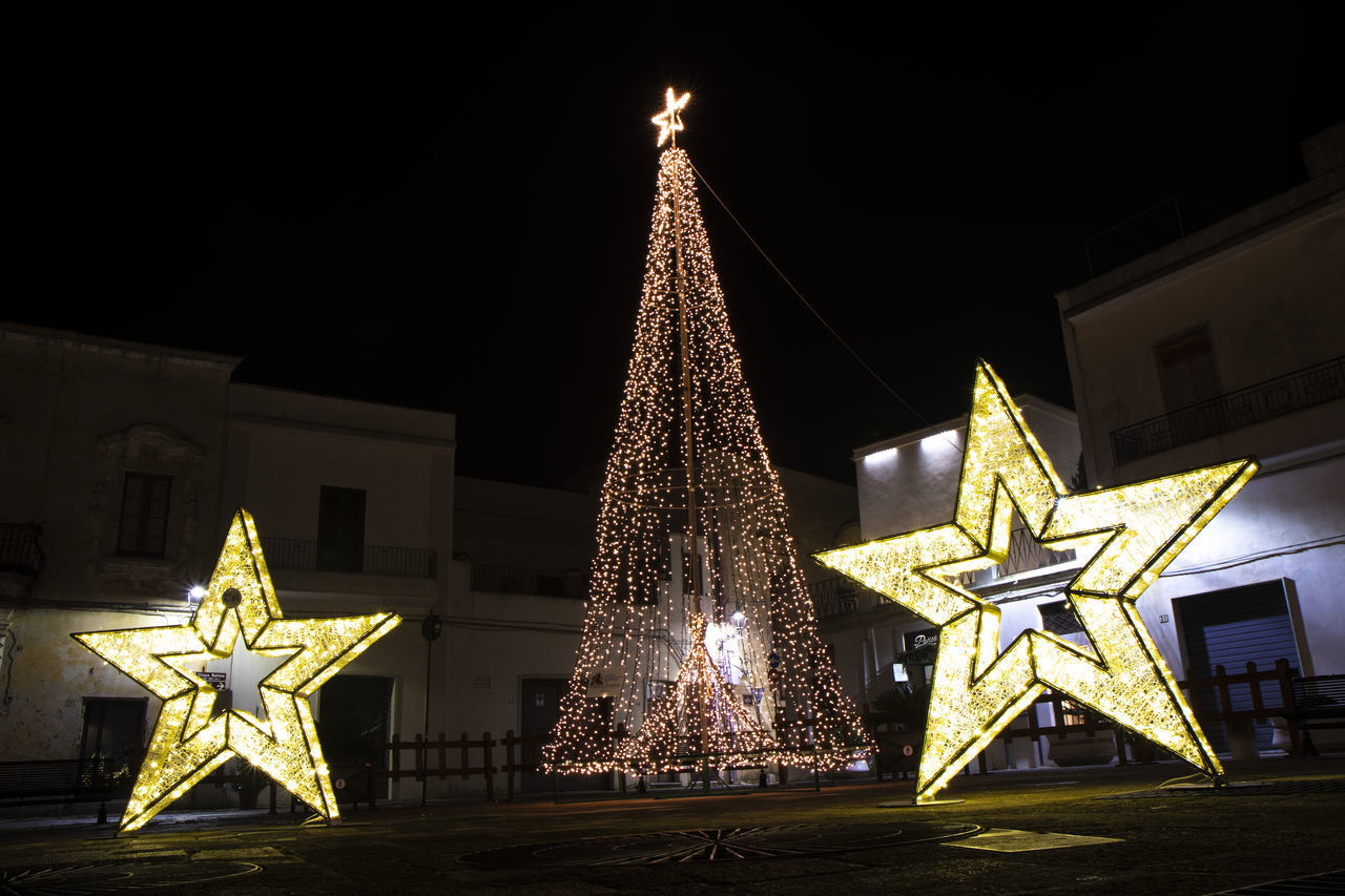 ILLUMINATED CHRISTMAS TREE AT NIGHT DURING FESTIVAL