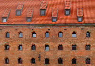 Low angle view of arch windows on brick wall