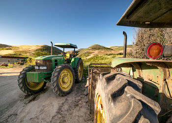 Tractor on field against clear sky