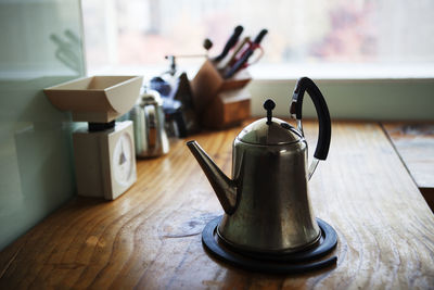 Metallic teapot at kitchen counter