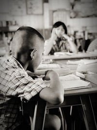 Boy sitting on table