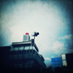 Low angle view of building against cloudy sky