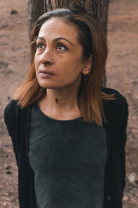 Portrait of young woman standing outdoors