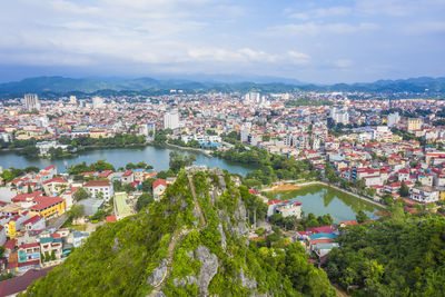 High angle view of townscape by river against sky